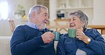 Happy, coffee and senior couple in conversation in the living room of modern home together. Smile, cheers and elderly man and woman in retirement talking, relaxing and drinking latte in the lounge.