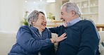 Mature, man and woman with joke in home on sofa in living room, together and bond. Elderly couple, smile and laugh in happiness with touch, humor and fun for relationship with love in retirement 