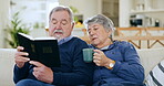 Home, relax and senior couple with bible, conversation and religion with support, guidance and bonding. Christian, elderly man and old woman on a couch, holy scripture and spiritual with worship 