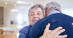 Home, hug and senior couple with support, love and commitment with respect, smile and retirement in a lounge. Apartment, old man and elderly woman embrace, marriage and romance with care and trust