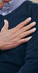 Hand, chest of elderly person and heart attack, anxiety or pain with disease and hypertension closeup. Cardiac fail, medical condition and angina, old age with emergency and cardiovascular healthcare