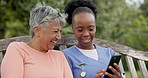 Senior, woman and caregiver with phone in nature with communication, laughing and happiness for meme. Elderly, black people and nurse with smartphone on swing with social media and internet joke