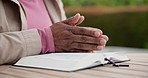 Praying, bible and hands of person in garden for spiritual meditation, religious reading and guidance. Religion, nature and closeup of holy book for worship, hope or belief in christ, god and Jesus