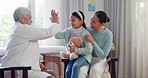 Doctor, mother and girl with high five in consultation, talking and success for assessment, review or care. Senior pediatrician, mom and sick daughter for conversation, notebook and medical history