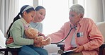 Mature doctor, child and stethoscope for teddy bear with consultation of sick girl at hospital for healthcare. Patient exam, wellness and pediatrician with kid and mom with consulting at family GP 