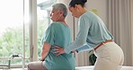 Doctor, bed and patient for massage by chiropractor, back pain and spine alignment with sciatica. Mature woman, specialist and clinic with help in healthcare, walker and orthopaedic support in injury