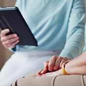 Holding hands, clinical therapist and tablet consultation with patient ...