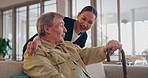 Caregiver, retirement and elderly man on sofa for medical support, rehabilitation and wellness. Nursing home, healthcare and woman with elderly patient on couch for conversation, helping and healing