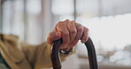 Walking stick, hands and elderly person with disability in home for healthcare, support and help for rehabilitation. Closeup, lonely senior and cane for balance of parkinson, arthritis and retirement