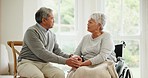 Wheelchair, senior couple and love with conversation in a retirement home with support and holding hands. Happy and woman with a disability with speaking and discussion with empathy in marriage