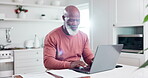 Senior man, laptop and remote working in kitchen, house and documents for business, typing and email. Entrepreneur, technology or worker for work from home, job or online for company, projects or web