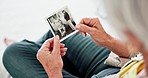 Closeup, home and senior woman with a picture, memory and remember with nostalgia, history and thinking. Hands, elderly lady or pensioner with an image, vintage and retail with photograph in a lounge