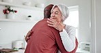 Interracial, couple and hug with love and support at home, comfort with empathy or hello, peace and old people. Retirement, life partner with black man and woman in marriage with embrace in kitchen