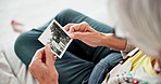 Closeup, home and old woman with a picture, photograph and remember with nostalgia, history and thinking. Hands, elderly lady or pensioner with an image, vintage and retail with memory in a lounge