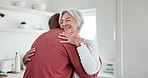 Interracial, couple and hug with trust and support at home, comfort with empathy or hello, love and old people. Retirement, life partner with black man and woman in marriage with embrace in kitchen