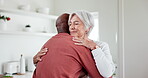 Interracial, people and hug with love and support at home, comfort with empathy or hello, peace and old couple. Retirement, life partner with black man and woman in marriage with embrace in kitchen