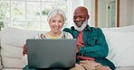 Old couple on sofa with laptop, movies and relax with love, interracial marriage and online bonding in home. Computer, streaming website and happy people, senior man and woman on couch in living room