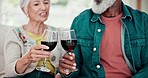 Home, cheers and senior couple with red wine, celebration and anniversary with happiness, interracial and relax. Toast, elderly man and old woman with alcohol, glasses and marriage with relationship