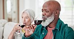 Home, drinking and senior couple with red wine, celebration and anniversary with happiness, interracial and relax. Happy, elderly man or old woman with alcohol, glasses and marriage with relationship