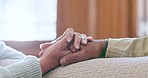 Senior couple, holding hands and relax with empathy, kindness and care in a home. Retirement, marriage hope and calm elderly people together with trust and support for healing and love in a house