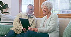 Happy senior couple, tablet and sofa to download news app, reading social media post or ebook. Elderly man, woman and interracial partner scroll on digital blog, online shopping or talk in retirement