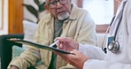 Doctor, patient and consultation in elderly care on clipboard for life insurance or health advice at home. Closeup of medical surgeon or nurse consulting senior man on prescription, diagnosis or plan