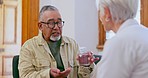 Pills, consulting and man with doctor in home for medical service, care and prescription. Healthcare, clinic and senior person on sofa with medicine for diagnosis, tablets and wellness in living room