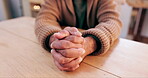 Man, hands or praying to worship God in religion for faith, guidance or gratitude on table in home. Praise closeup, spiritual person or prayer with belief, blessing or hope for support, help or trust