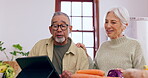 Cooking, learning or old couple with tablet or food for a healthy diet together in retirement at home. Online, interracial or happy senior woman in kitchen talking to an elderly man for dinner recipe