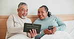 Smartphone, tablet and senior couple in bed, typing and talking together in the morning. Technology, happy man and interracial woman in bedroom on internet, social media and online shopping at home