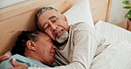 Love, sleep and a senior couple in bed together in the morning to relax on a weekend during retirement. Hug, home or bedroom with an elderly pensioner man and woman resting for peace or quiet