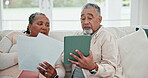 Senior couple, documents and technology for home bills, financial planning and debt or loan application on tablet. Elderly people on sofa with digital technology, paperwork and taxes or asset report