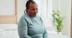 Senior African woman, sad and bedroom in retirement with thinking of grief, mental health and remember regret. Elderly lady, anxiety and depression with bad memory, ideas and worry in nursing home