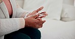 Massage hands, pain and closeup of arthritis, sick or disease in home living room. Touch fingers, inflammation and woman with injury, muscle fibromyalgia or rheumatoid, health problem or osteoporosis