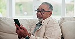 Smile, relax and a senior man with a phone for communication, reading social media and chat. Happy, home sofa and an elderly man scrolling on a mobile app for news, web search or online connection