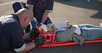 Hands, emergency first aid and a paramedic team with a patient or victim on the street for accident treatment. Healthcare, medical or oxygen with an emt and colleague working to rescue a person