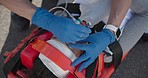 Emergency service, paramedic and hands with a light for a woman, healthcare and safety training. Help, accident and a medical employee with equipment for a patient with an injury and attention