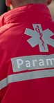 Paramedic man, walking and emergency on street with back, uniform and outdoor for medical attention. First responder, healthcare expert and accident on road for care, support and closeup for safety