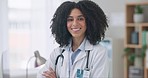 Happy woman, face and professional doctor with arms crossed in healthcare, medical or career ambition at hospital. Portrait of female person, nurse or surgeon smile in confidence for health service