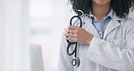 Woman, stethoscope and hand of doctor in healthcare, medical or professional service at hospital. Closeup of female person, nurse or surgeon with tool or equipment for heart beat, health and wellness