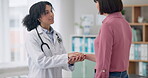 Doctor, woman and holding hand in office with communication for healthcare, medical support or wellness. Professional, expert or person with patient for conversation, advice or consultation at clinic