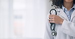 Woman, stethoscope and hand of doctor in medical, healthcare or professional service at hospital. Closeup of female person, nurse or surgeon with tool or equipment for heart beat, health and wellness