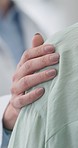 Hands of doctor, support or shoulder of patient in hospital for healthcare, consulting or wellness in clinic. Closeup, nurse or sick person with cancer in consultation with empathy, grief or trust 