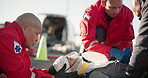 Hands, medical and emergency with a paramedic team on the scene of an accident to rescue a person. Healthcare, medicine and emt services with a group of people in uniform helping an injured victim