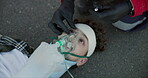 Man, paramedic and hands with flashlight in eyes with oxygen mask for emergency, accident or healthcare in road. First responder, person and medical service in street for assistance, help or patient