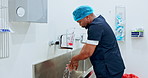 Surgeon washing hands, hygiene and doctor man, safety and water for cleaning away bacteria with healthcare. Health, wellness and African medical professional prepare for surgery with disinfection