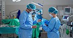 Surgeon mask, gloves and nurse help with dressing, preparation and getting ready in operation theatre. Medical team, surgery and doctor wear ppe uniform for healthcare emergency of people in hospital