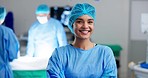 Happy woman, surgeon and arms crossed, face and confidence with help, support and trust in healthcare. Smile in portrait, cardiology doctor in operation theater for surgery with medical professional