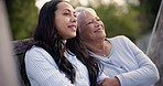 Park, conversation and woman with senior mother outdoor, communication and bonding together, care and support. Adult daughter talking to happy mom on bench in garden, connection and love of family