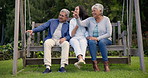 Bench, park and senior parents with woman in nature and hug on holiday or vacation for bonding together with love. Laughing, outdoor and elderly people pointing or embrace in happiness with daughter